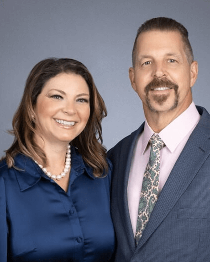 Professional headshots of James and Teresa together smiling